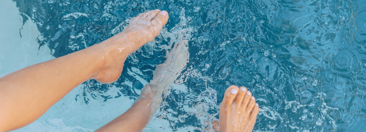 Feet splashing in pool.