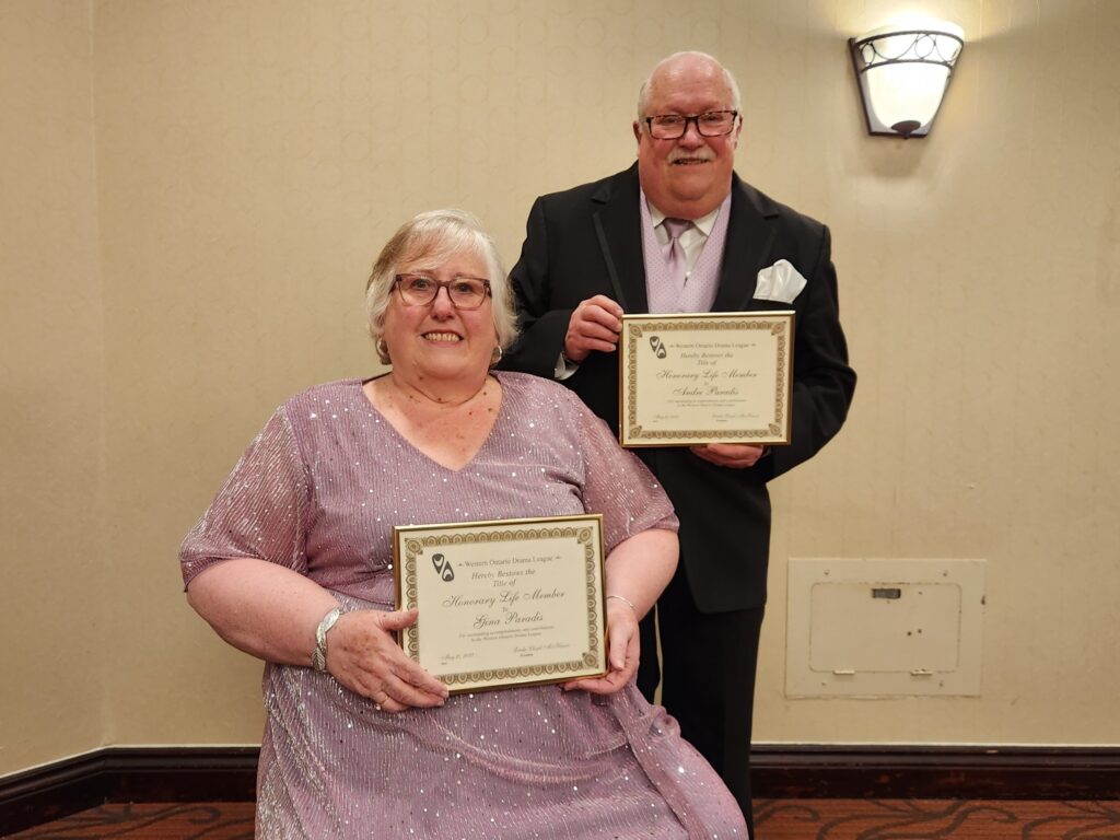 Gina and Andre Paradis holding their WODL Life Member Awards.